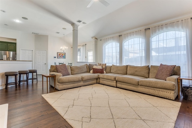 7200 Randall Way, Plano, TX 75025 - living area with dark wood-style flooring, decorative columns, a chandelier, and ceiling fan