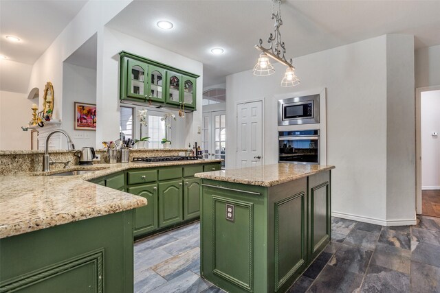 7200 Randall Way, Plano, TX 75025 - kitchen with green cabinetry, appliances with stainless steel finishes, a sink, and stone tile flooring
