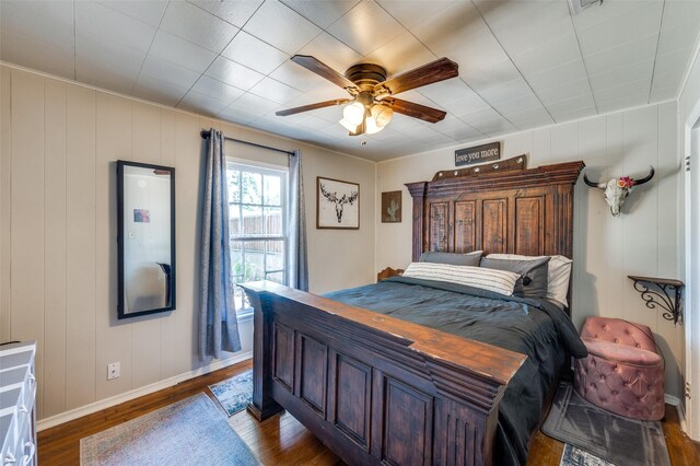 1119 Mccormick St, Denton, TX 76201 - bedroom with dark wood-style floors, baseboards, ceiling fan, and a decorative wall