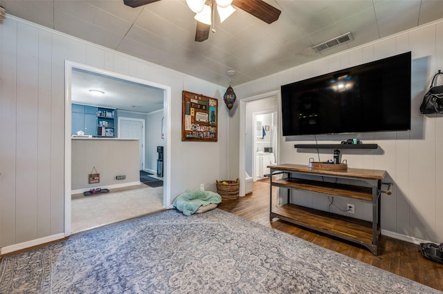 1119 Mccormick St, Denton, TX 76201 - living area with wood finished floors, a ceiling fan, baseboards, a decorative wall, and crown molding
