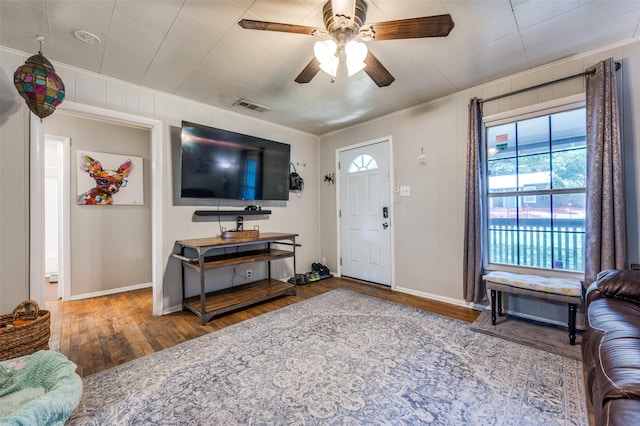 1119 Mccormick St, Denton, TX 76201 - living room with healthy amount of natural light, wood finished floors, crown molding, a ceiling fan, and baseboards