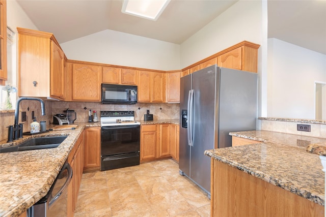 kitchen featuring appliances with stainless steel finishes, a sink, light stone counters, lofted ceiling, and backsplash