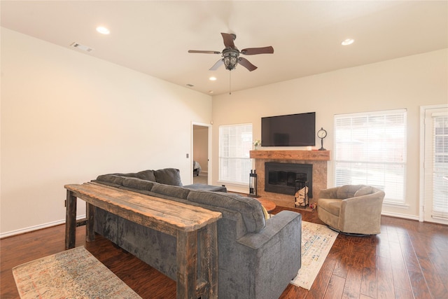 living room featuring ceiling fan, healthy amount of natural light, a glass covered fireplace, dark wood-style flooring, and recessed lighting