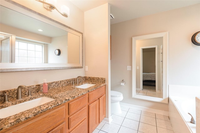 bathroom with toilet, tile patterned flooring, a garden tub, baseboards, and double vanity