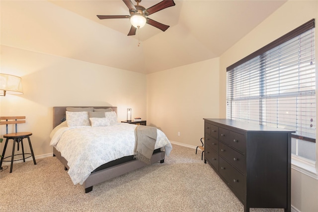 bedroom with light carpet, lofted ceiling, baseboards, and ceiling fan