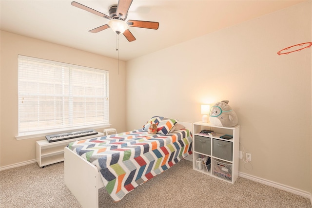 bedroom featuring carpet floors, multiple windows, baseboards, and ceiling fan