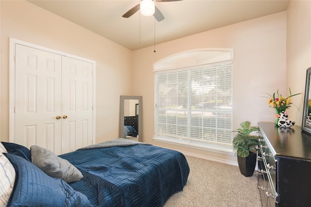 bedroom featuring carpet flooring, a closet, ceiling fan, and baseboards