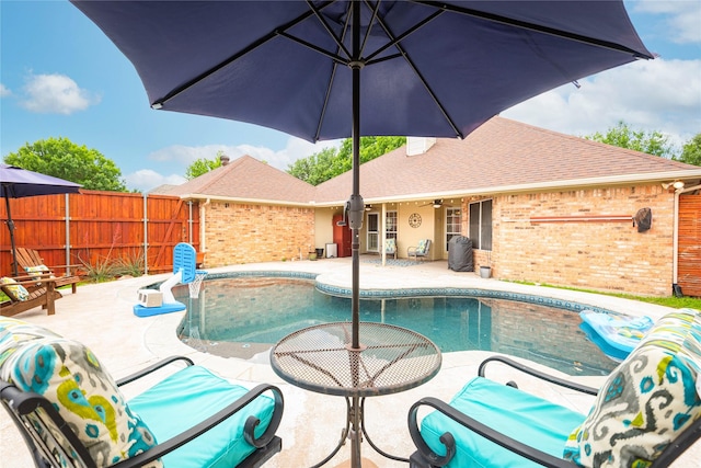 view of pool with a fenced backyard, a patio area, and ceiling fan