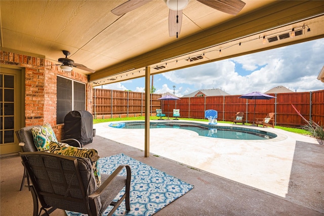 view of swimming pool with ceiling fan, a fenced backyard, and a patio
