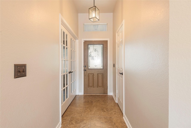 doorway to outside featuring baseboards