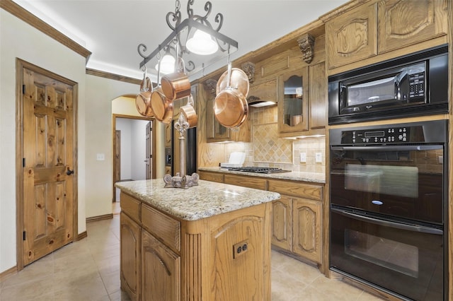 9008 Reata W Dr, Benbrook, TX 76126 - kitchen with black appliances, arched walkways, a center island, light tile patterned floors, and crown molding