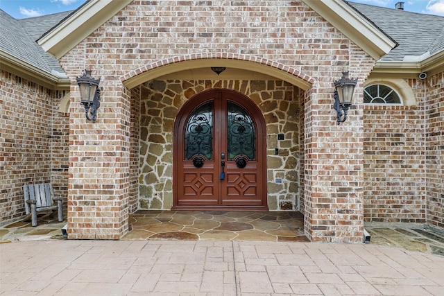 9008 Reata W Dr, Benbrook, TX 76126 - entrance to property with brick siding, roof with shingles, and french doors