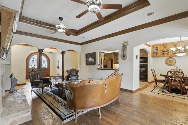 9008 Reata W Dr, Benbrook, TX 76126 - living room with arched walkways, ceiling fan, a chandelier, a raised ceiling, and ornamental molding
