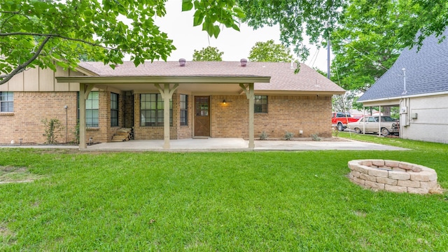 309 W 5th St, Justin, TX 76247 - rear view of property with brick siding, an outdoor fire pit, a yard, a patio, and roof with shingles