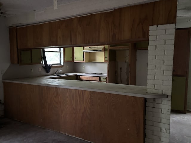 207 County Road 1739, Yantis, TX 75497 - kitchen featuring white gas cooktop, a peninsula, light countertops, unfinished concrete floors, and a sink