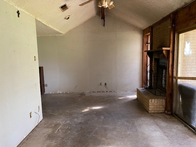 501 S Clay St, Henrietta, TX 76365 - unfurnished living room featuring a brick fireplace, a ceiling fan, and vaulted ceiling