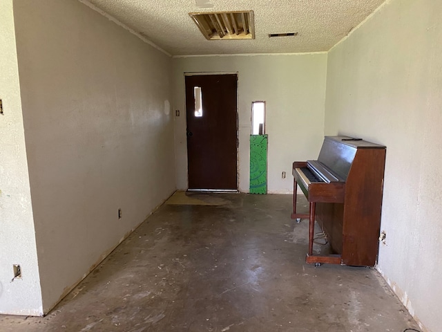 501 S Clay St, Henrietta, TX 76365 - entryway with concrete flooring and a textured ceiling