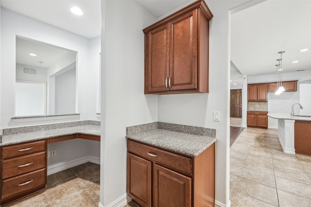 1056 Enchanted Rock Dr, Allen, TX 75013 - kitchen featuring tasteful backsplash, light tile patterned flooring, a sink, recessed lighting, and hanging light fixtures