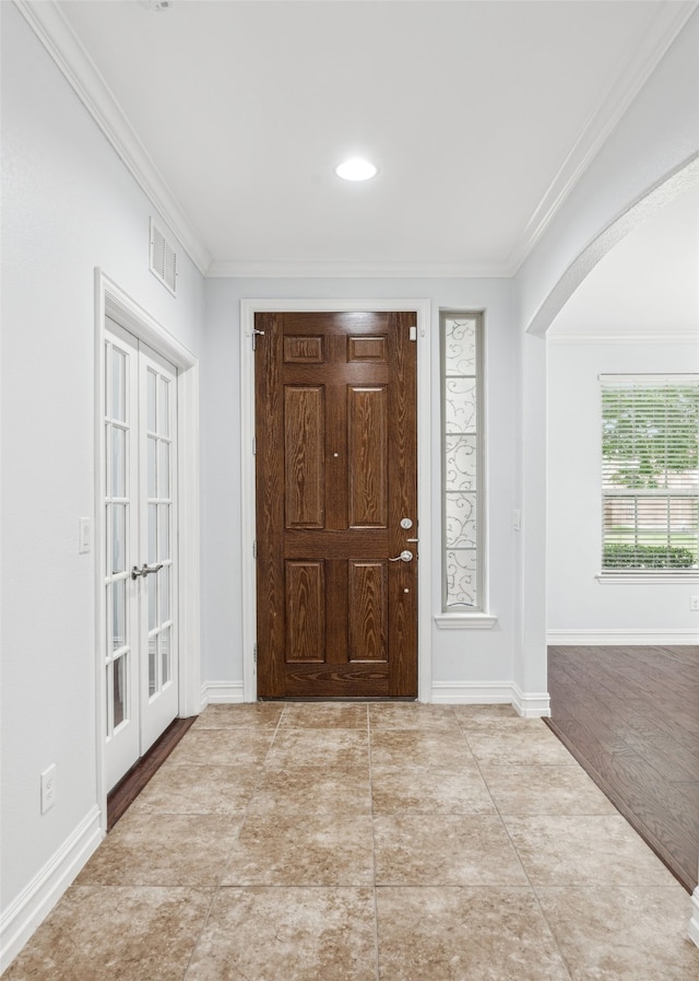 1056 Enchanted Rock Dr, Allen, TX 75013 - foyer entrance featuring ornamental molding, arched walkways, baseboards, and french doors