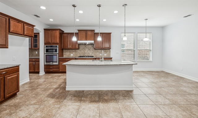 1056 Enchanted Rock Dr, Allen, TX 75013 - kitchen with under cabinet range hood, stainless steel appliances, decorative backsplash, a sink, and hanging light fixtures