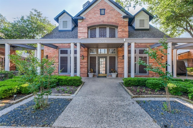 2524 Preston Rd Unit 204, Plano, TX 75093 - view of front of property with brick siding, a shingled roof, and a porch