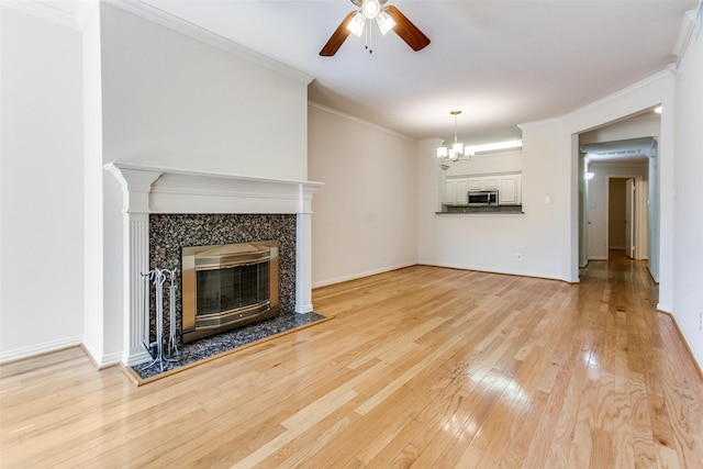 2524 Preston Rd Unit 204, Plano, TX 75093 - unfurnished living room with ceiling fan, light wood-type flooring, a chandelier, a fireplace, and crown molding