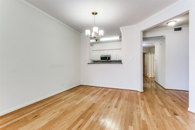 2524 Preston Rd Unit 204, Plano, TX 75093 - unfurnished dining area featuring light wood finished floors, a chandelier, baseboards, and ornamental molding