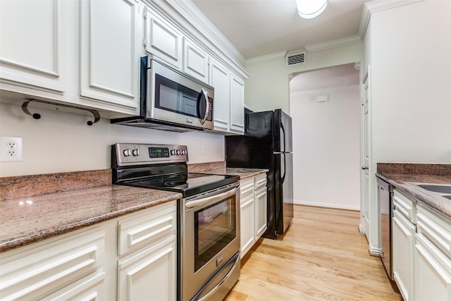 2524 Preston Rd Unit 204, Plano, TX 75093 - kitchen with appliances with stainless steel finishes, ornamental molding, light wood-type flooring, stone counters, and white cabinets