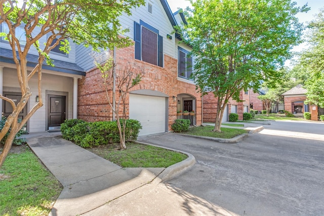2524 Preston Rd Unit 204, Plano, TX 75093 - view of front of property with a garage, brick siding, and driveway