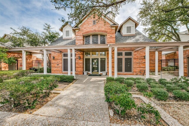 2524 Preston Rd Unit 204, Plano, TX 75093 - traditional-style home featuring brick siding, a shingled roof, and fence