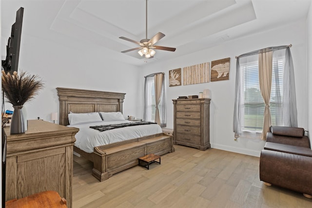 7020 Valley View Dr, Joshua, TX 76058 - bedroom featuring a tray ceiling, light wood-style floors, baseboards, and ceiling fan