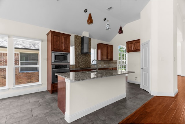 8204 Saint Clair Dr, Mckinney, TX 75071 - kitchen featuring stainless steel appliances, wall chimney exhaust hood, dark stone countertops, tasteful backsplash, and an island with sink
