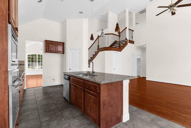 8204 Saint Clair Dr, Mckinney, TX 75071 - kitchen featuring a sink, a ceiling fan, high vaulted ceiling, appliances with stainless steel finishes, and a center island with sink