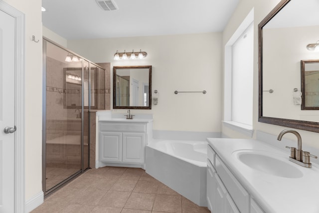 8204 Saint Clair Dr, Mckinney, TX 75071 - bathroom with a shower stall, two vanities, a bath, and tile patterned floors