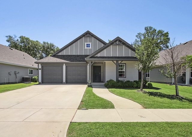 115 Rock Creek Ln, Terrell, TX 75160 - view of front of home with board and batten siding, an attached garage, a front yard, driveway, and central air condition unit