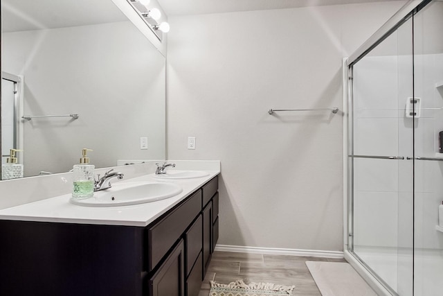 115 Rock Creek Ln, Terrell, TX 75160 - full bath featuring wood finished floors, a shower stall, baseboards, and double vanity