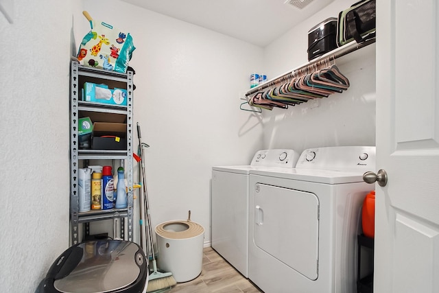 115 Rock Creek Ln, Terrell, TX 75160 - laundry room featuring washer and clothes dryer and light wood-style floors