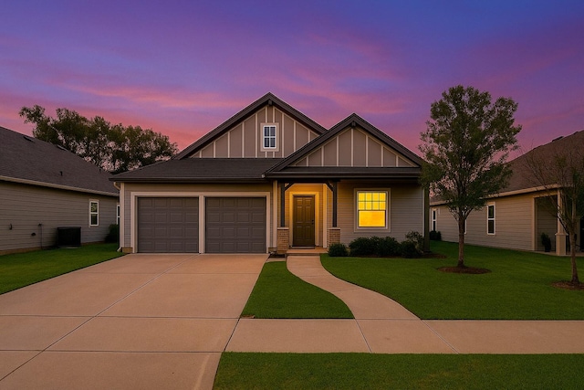 115 Rock Creek Ln, Terrell, TX 75160 - view of front facade with board and batten siding, driveway, a front yard, an attached garage, and central AC unit