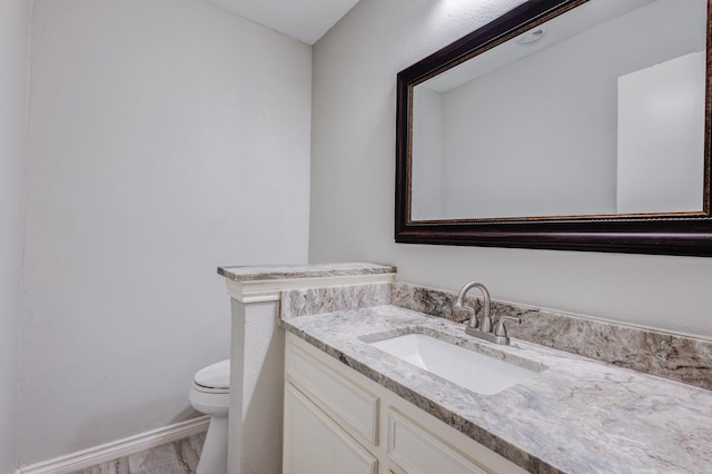 bathroom with toilet and vanity
