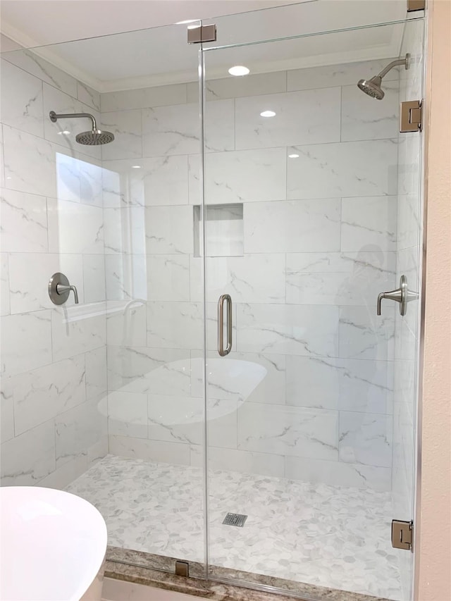 bathroom with a shower stall and toilet