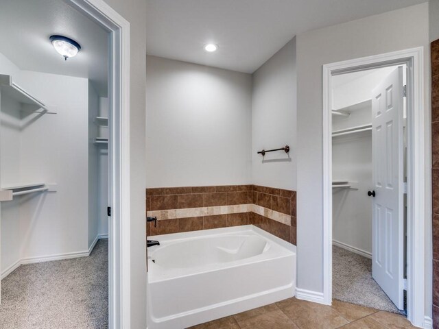 313 W Alene Dr, Mabank, TX 75147 - full bath featuring a garden tub, a spacious closet, baseboards, recessed lighting, and tile patterned flooring