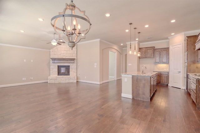 1306 Prato Ave, Mclendon Chisholm, TX 75032 - kitchen with a ceiling fan, a sink, crown molding, a center island with sink, and a stone fireplace