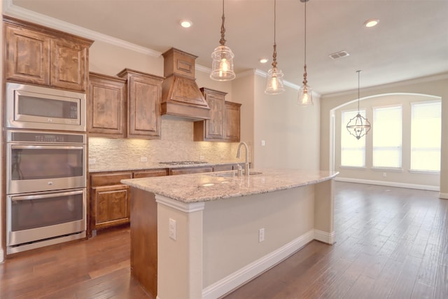 1306 Prato Ave, Mclendon Chisholm, TX 75032 - kitchen with a sink, stainless steel appliances, crown molding, backsplash, and brown cabinets