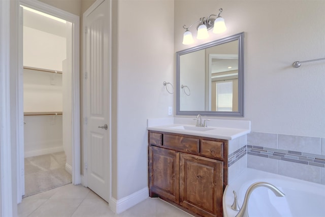 1306 Prato Ave, Mclendon Chisholm, TX 75032 - bathroom featuring vanity, tile patterned floors, a garden tub, and a walk in closet