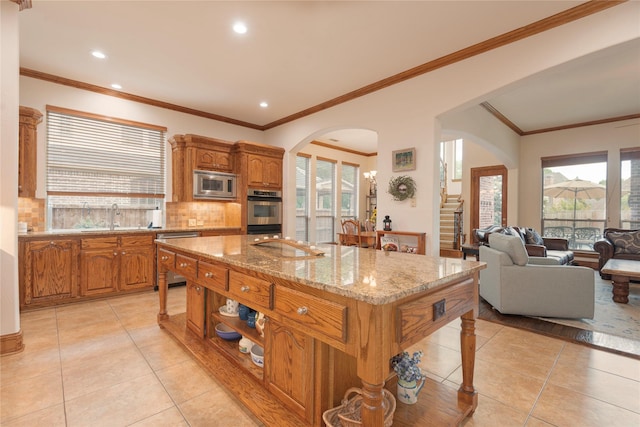 1607 Navarro Ct, Allen, TX 75013 - kitchen with appliances with stainless steel finishes, arched walkways, light tile patterned floors, a sink, and backsplash