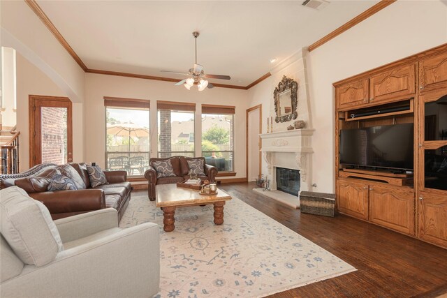 1607 Navarro Ct, Allen, TX 75013 - living room with dark wood-style flooring, a ceiling fan, a fireplace, and crown molding