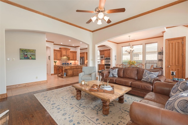 1607 Navarro Ct, Allen, TX 75013 - living area featuring arched walkways, a chandelier, ceiling fan, ornamental molding, and baseboards