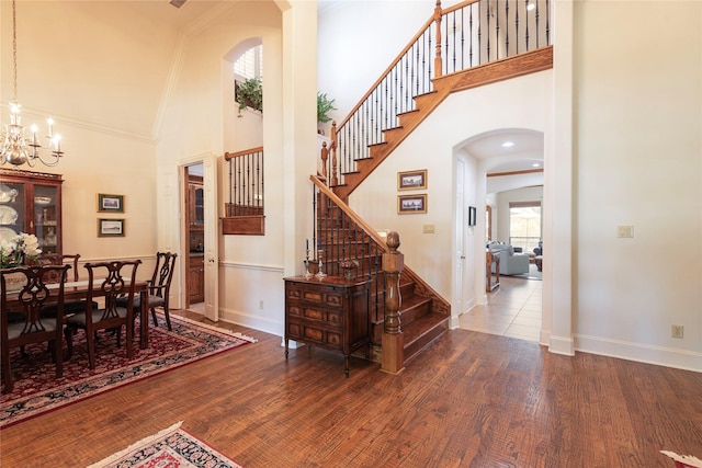 1607 Navarro Ct, Allen, TX 75013 - entryway featuring arched walkways, high vaulted ceiling, wood finished floors, baseboards, and crown molding