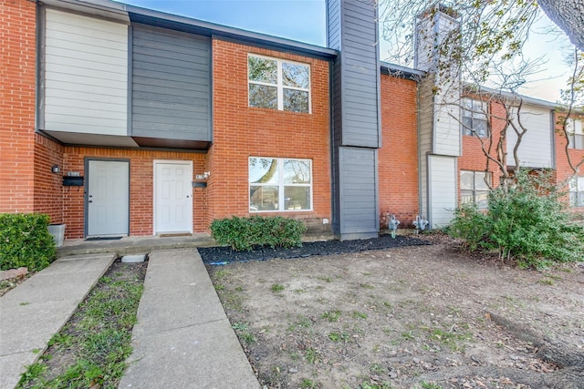 323 Towne House Ln, Richardson, TX 75081 - view of front of home featuring a chimney and brick siding