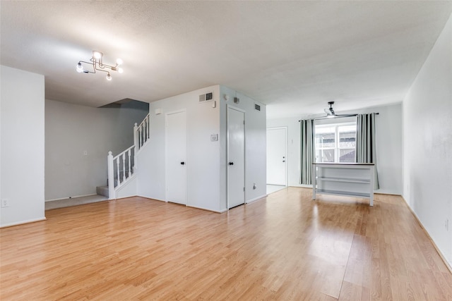 323 Towne House Ln, Richardson, TX 75081 - unfurnished room featuring light wood-style flooring, stairway, and baseboards